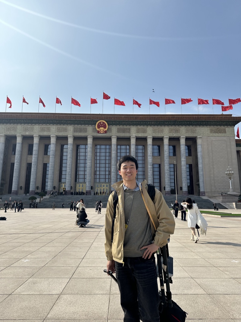 Dake Kang in front of the Great Hall of the People in Beijing